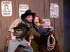 PHOTO 2: The not-so-notorious bandits 'Zeke' (Justin Roller) and 'Copper Penny' (Susan Dohan) plot their scheme to steal Sarsparilla City's prized root beer! Photo by Wesley Horton